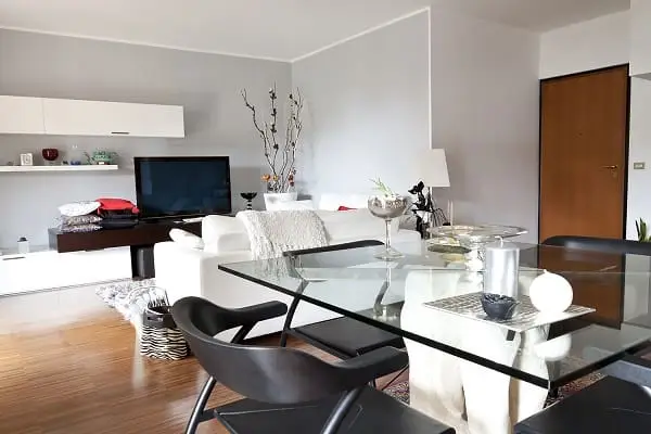 Contemporary living and dining area with glass table and minimalist decor