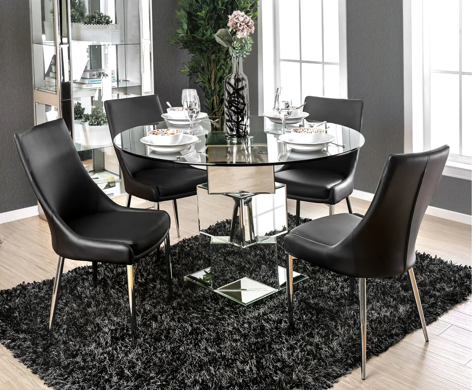 Modern dining area with a custom glass tabletop and sleek black chairs.