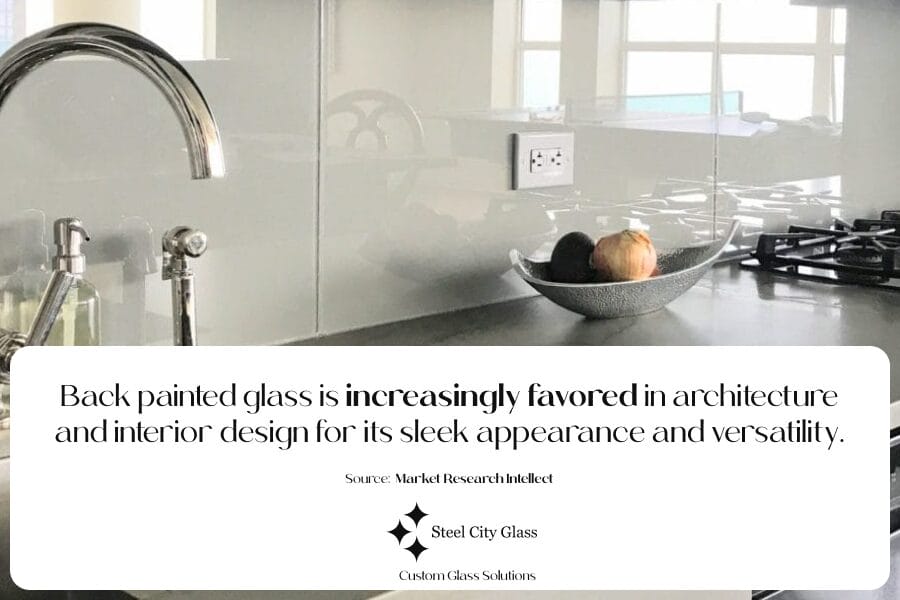 Kitchen and sink with back painted glass in background 

 