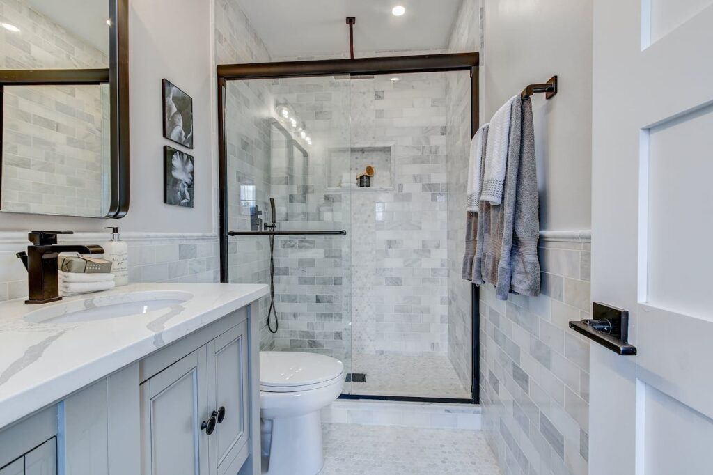 Semi-frameless glass shower door with black trim